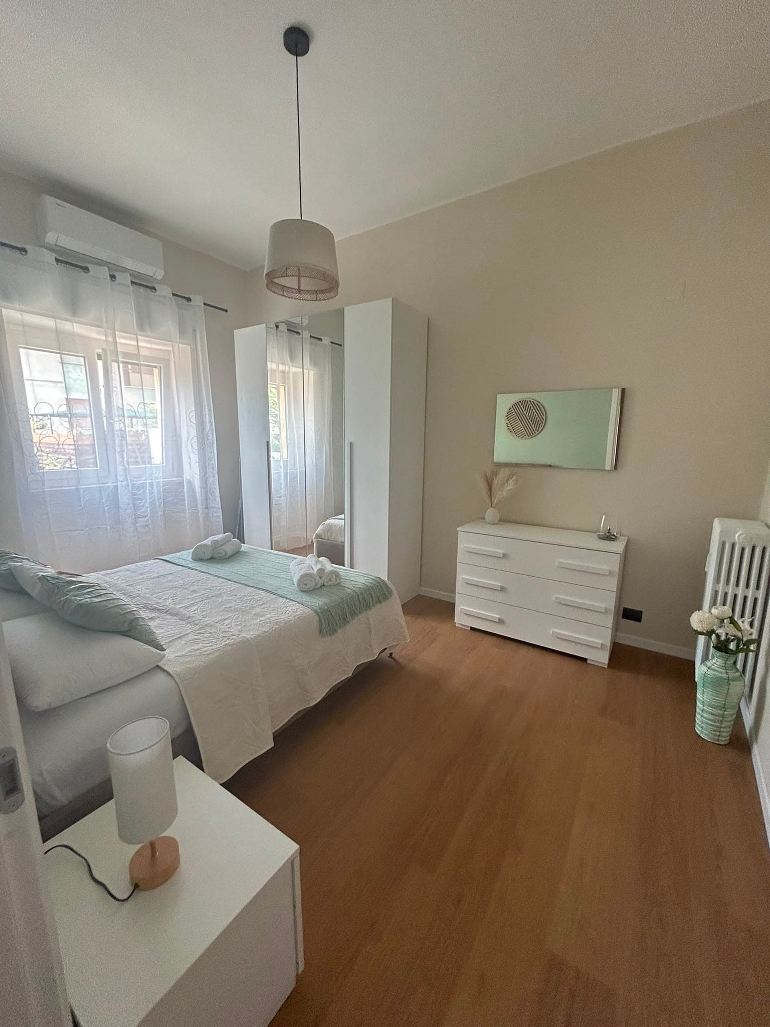 The bedroom on the wardrobe side, with chest of drawers and mirror