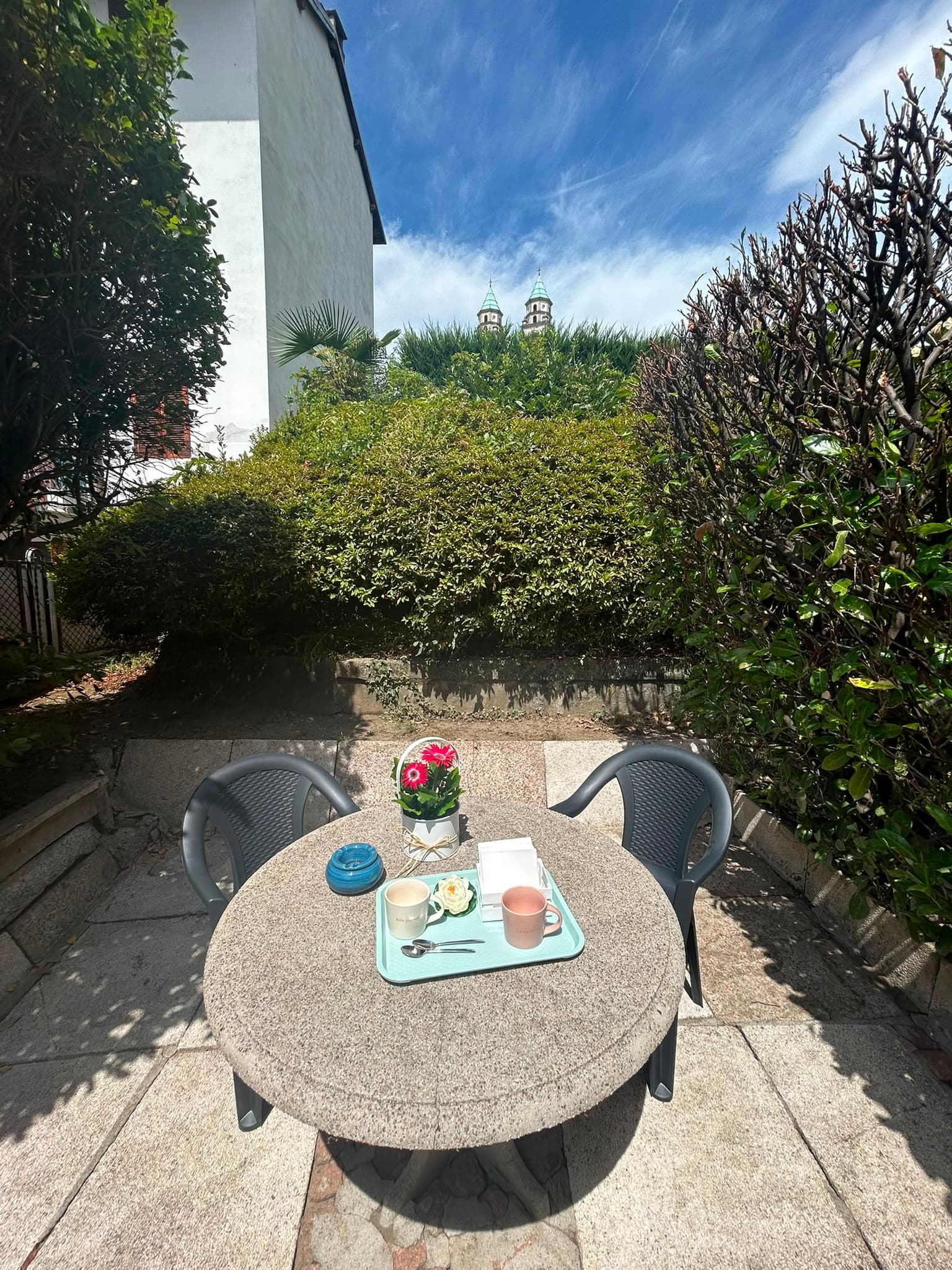 The shared garden at Mari's Home with a small table and chairs
