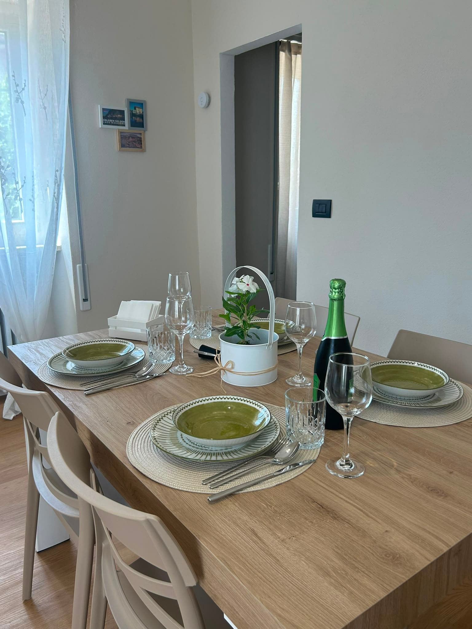 The table set with glasses and a bottle of sparkling wine