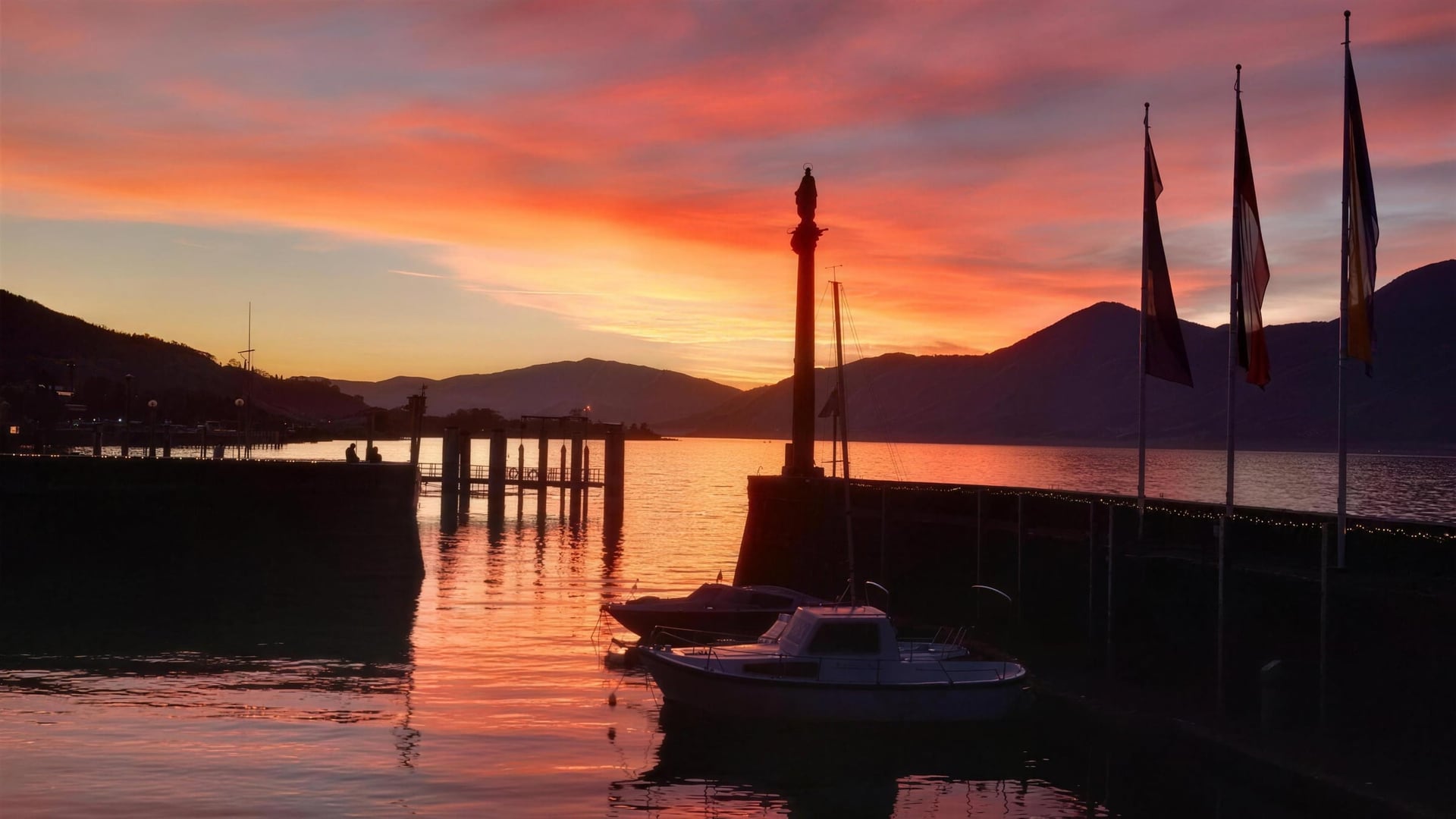 Luino harbour at sunset with a moored boat